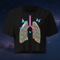 Front view of the black women’s crop top featuring Butterfly Lungs artwork with botanical and celestial details.