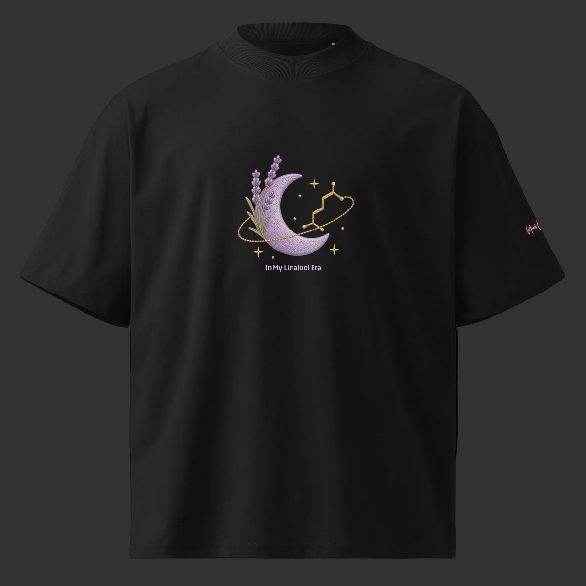 Front view of the black oversized tee featuring lavender, a purple crescent moon, linalool molecule and gold celestial accents.
