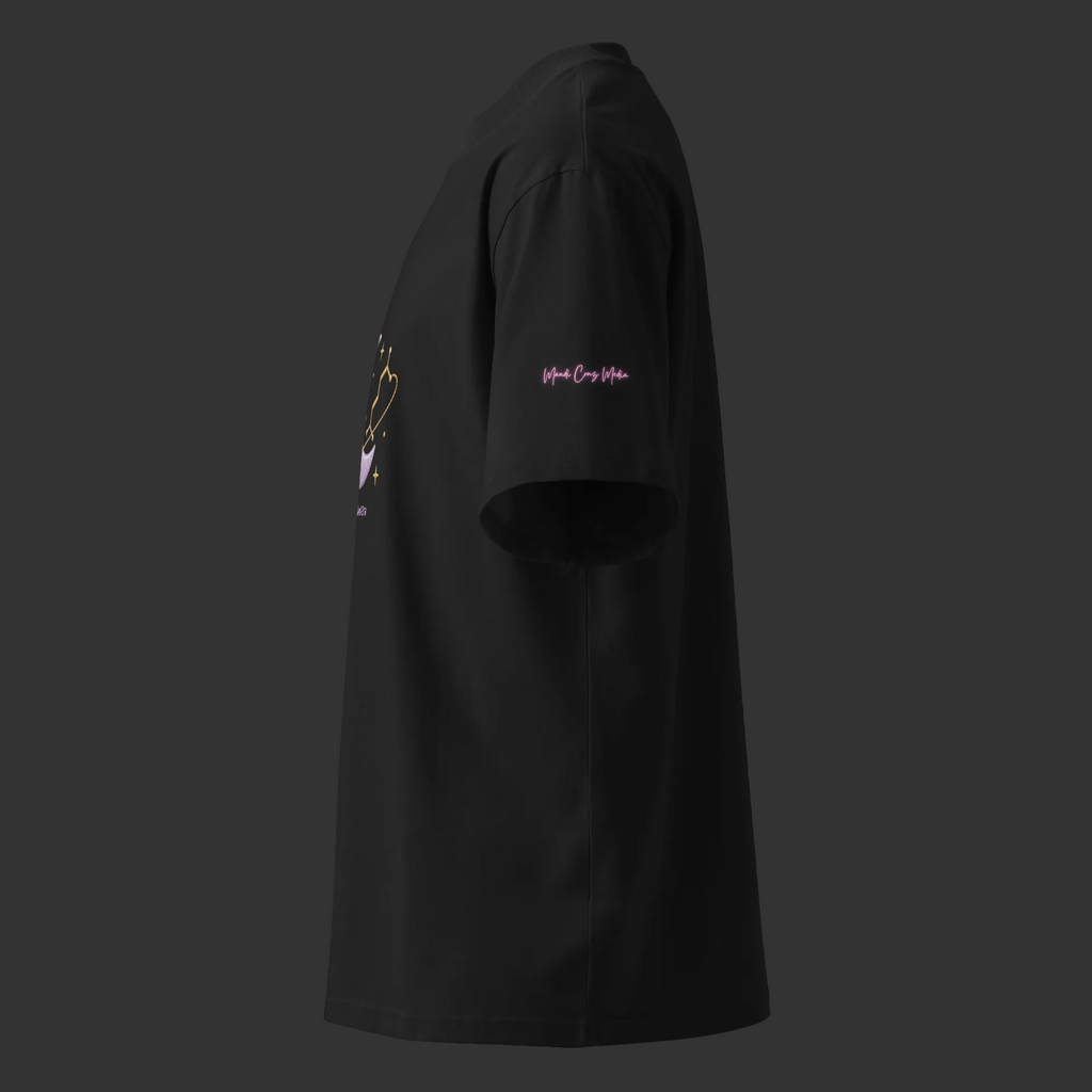 Left-side view of the black oversized tee showing its wide sleeve and pink Mandi Cruz Media signature.