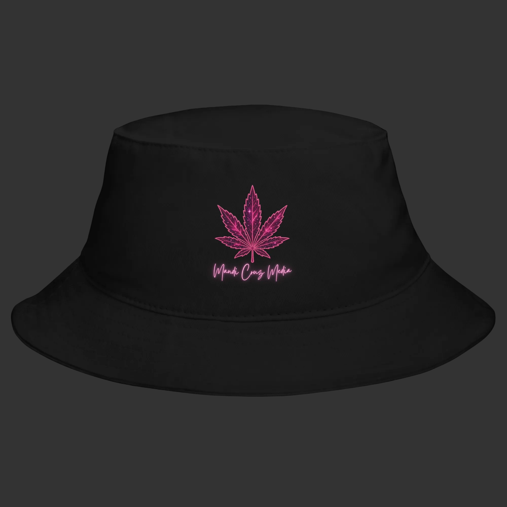 Front product view of the black cotton bucket hat embroidered with the signature pink Mandi Cruz Media leaf design.