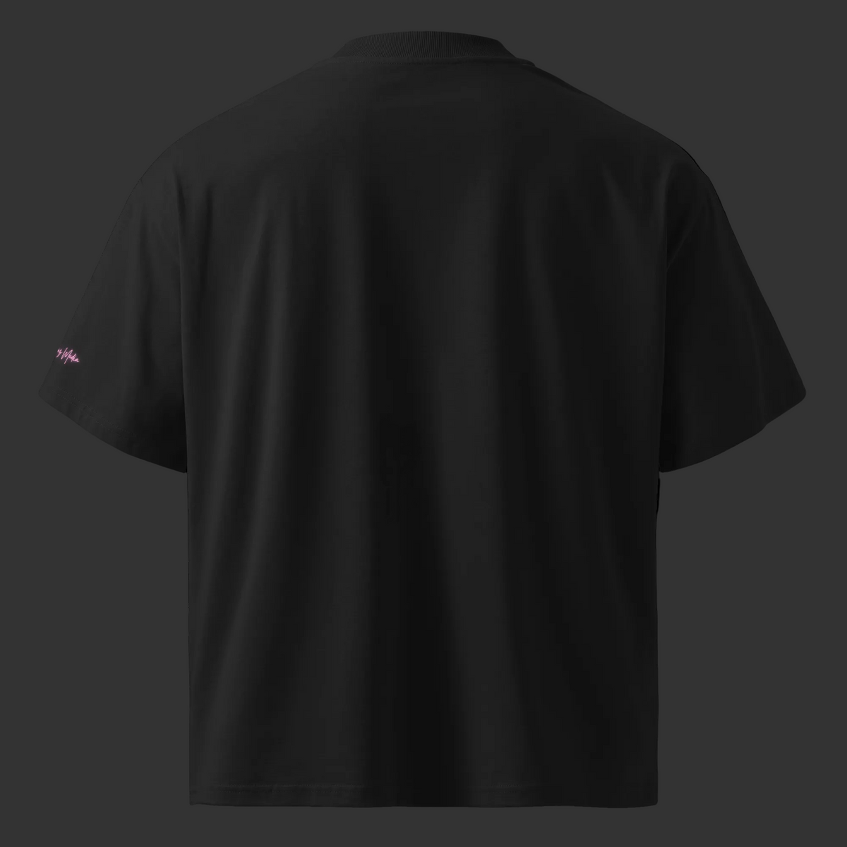 Back view of the black oversized organic tee with a plain finish and small pink Mandi Cruz Media sleeve signature.