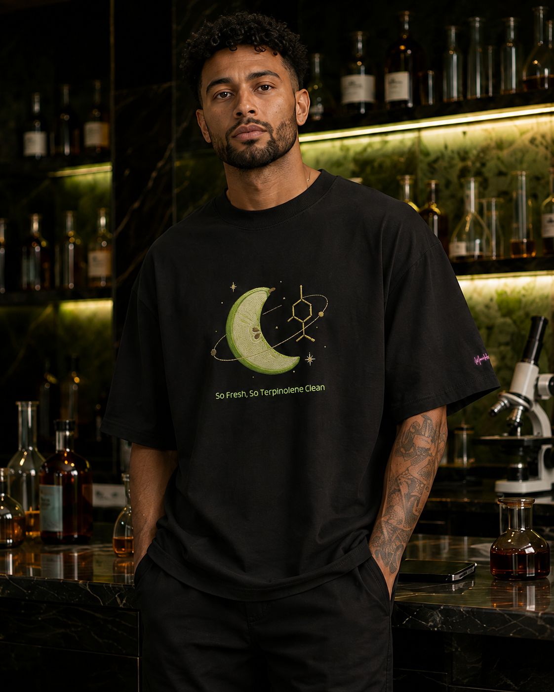 Man wearing the black So Fresh, So Terpinolene Clean oversized tee in a sophisticated botanical science loung