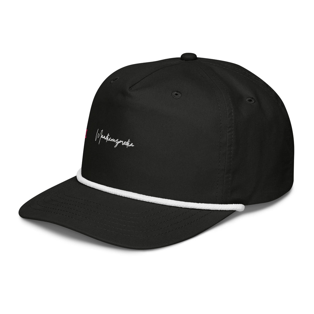 Left-front angle of the black embroidered golf cap showing the white rope trim and Mandi Cruz Media script.
