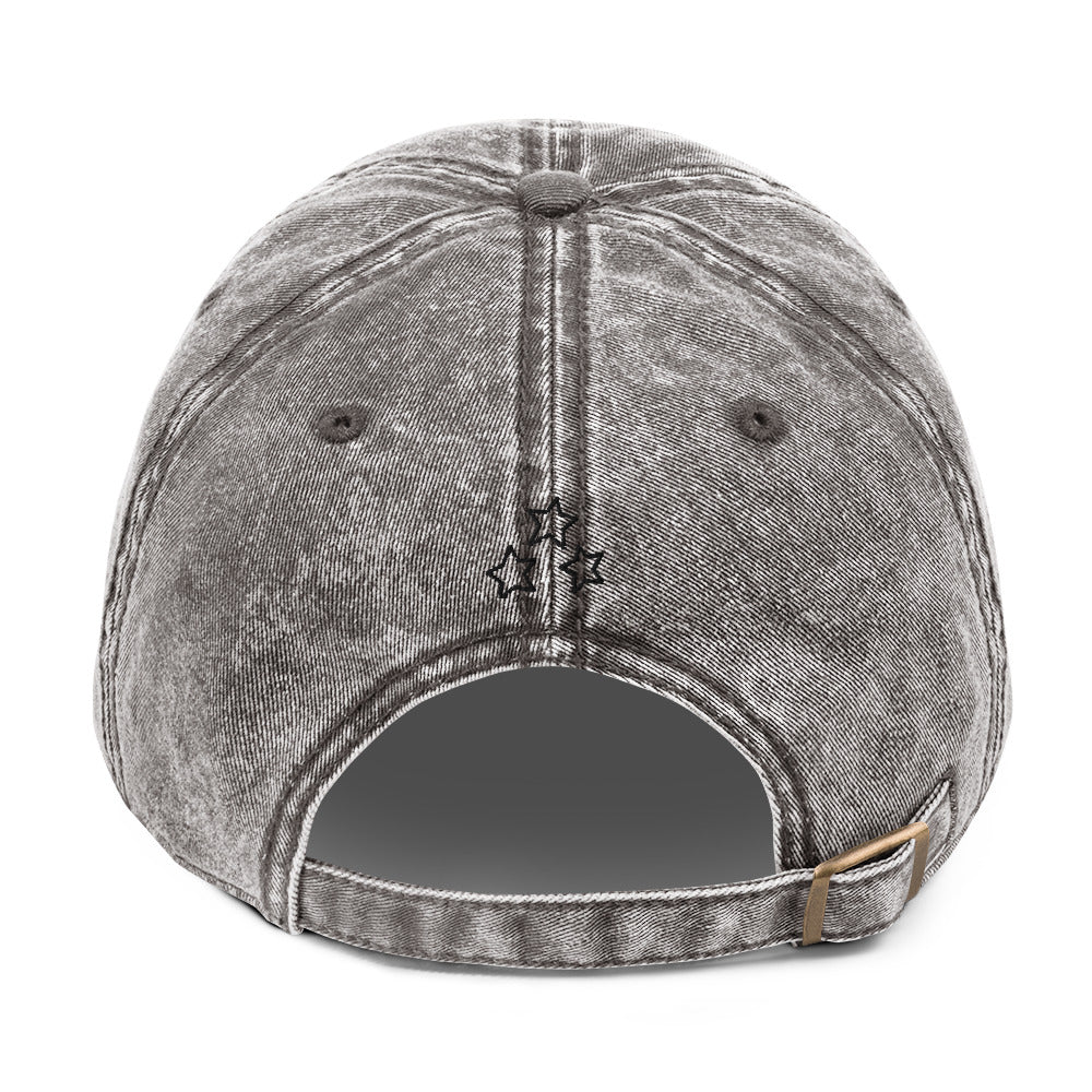 Back view of the charcoal grey vintage cap with three black embroidered stars and an adjustable brass buckle.