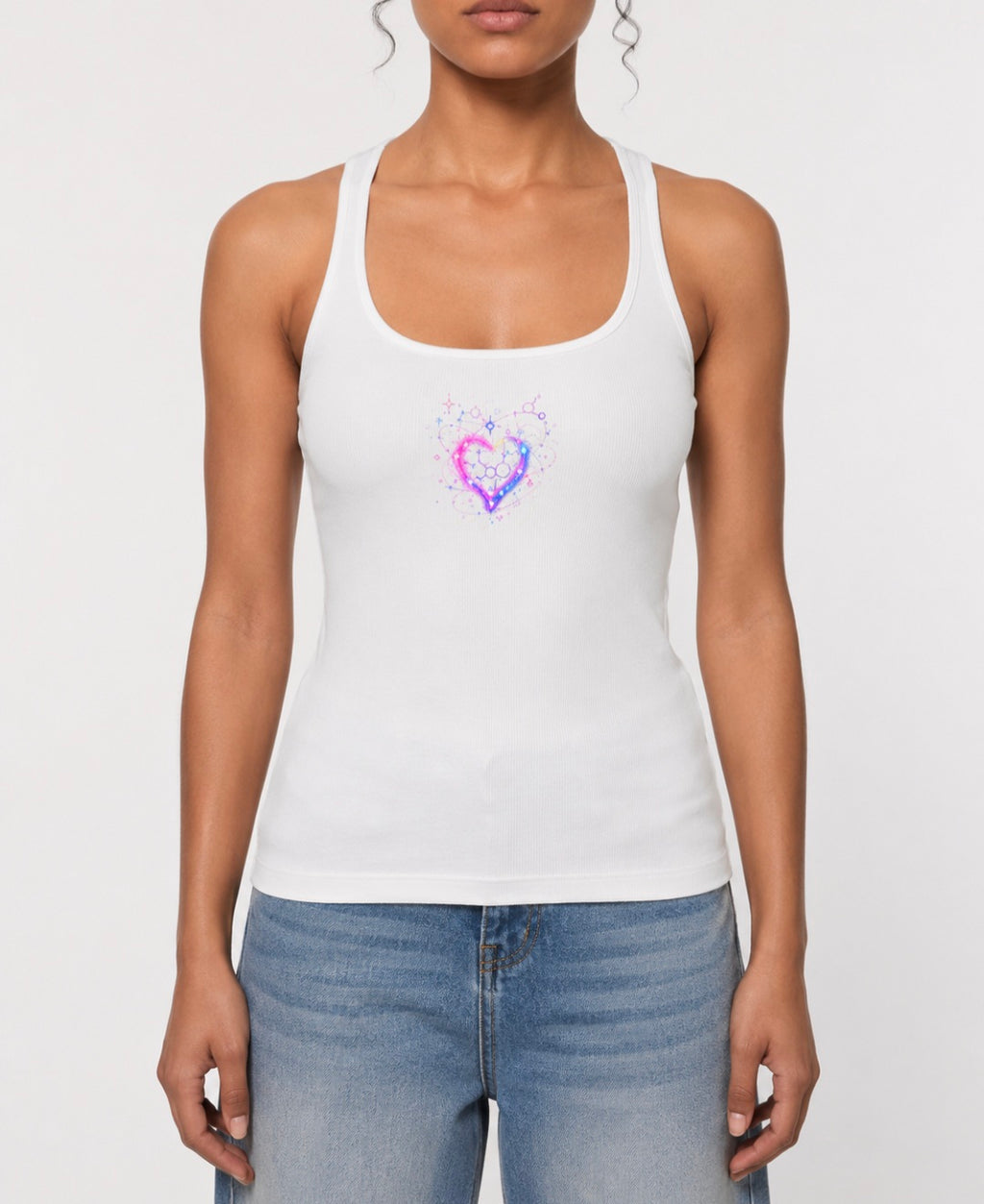 Front view of a woman wearing a white ribbed racerback tank featuring a pink, purple and blue cosmic heart with molecular details.