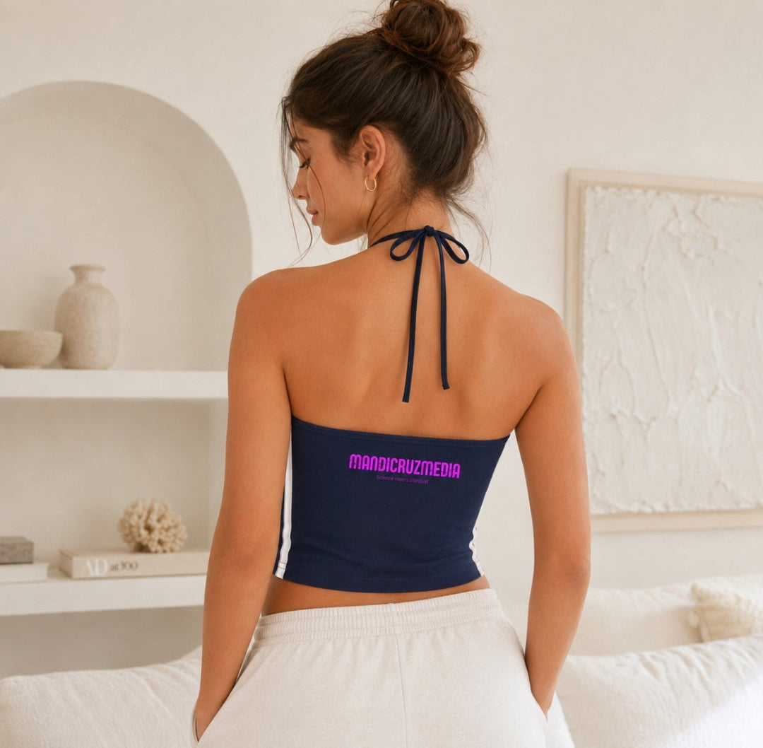 Woman modeling the back of the navy Cosmic Heart halter crop top with tie-neck straps and Mandi Cruz Media lo