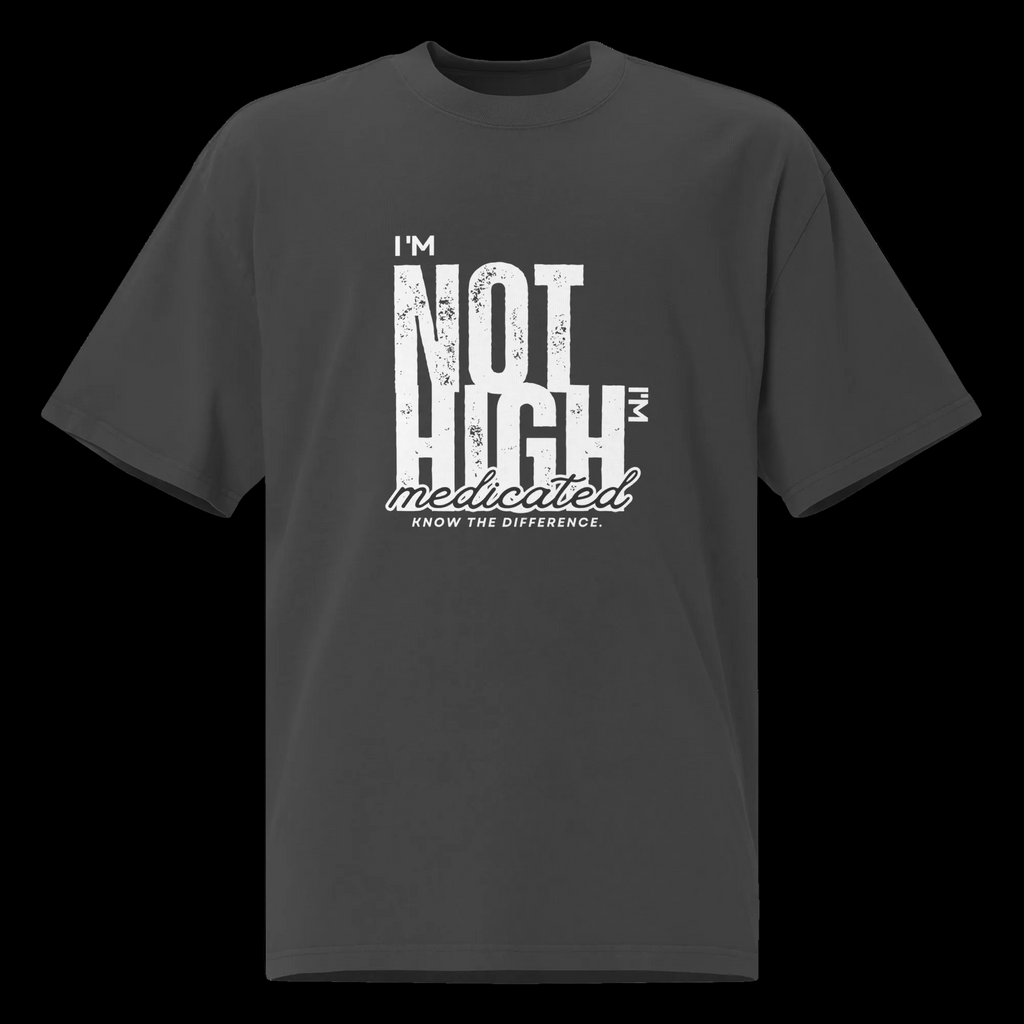 Front view of the faded black oversized tee Front view of the faded black oversized tee with a distressed white “I’m Not High, I’m Medicated” graphic and relaxed fit.