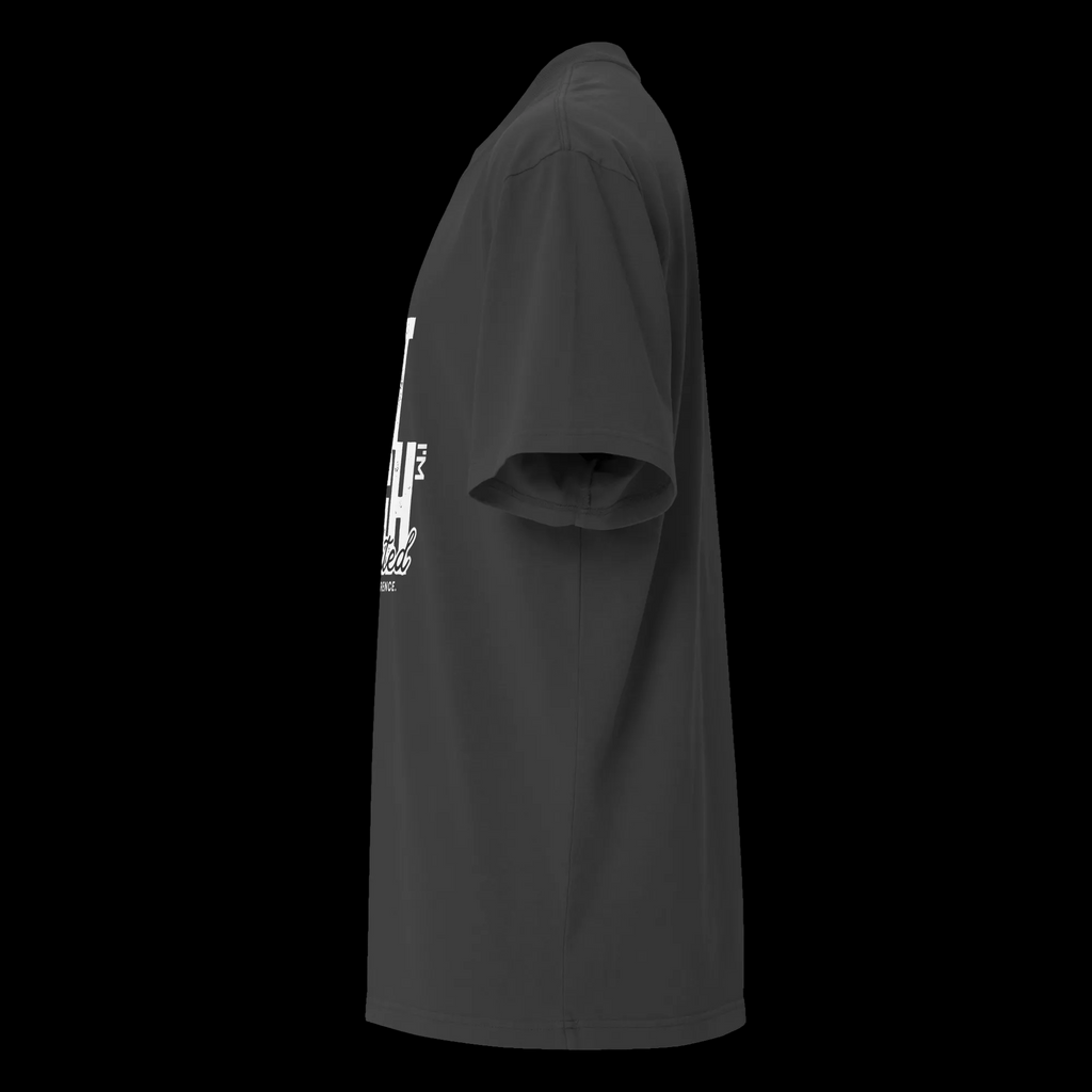 Left-side view of the faded black oversized tee showing the drop shoulder, wide sleeve and partial statement graphic