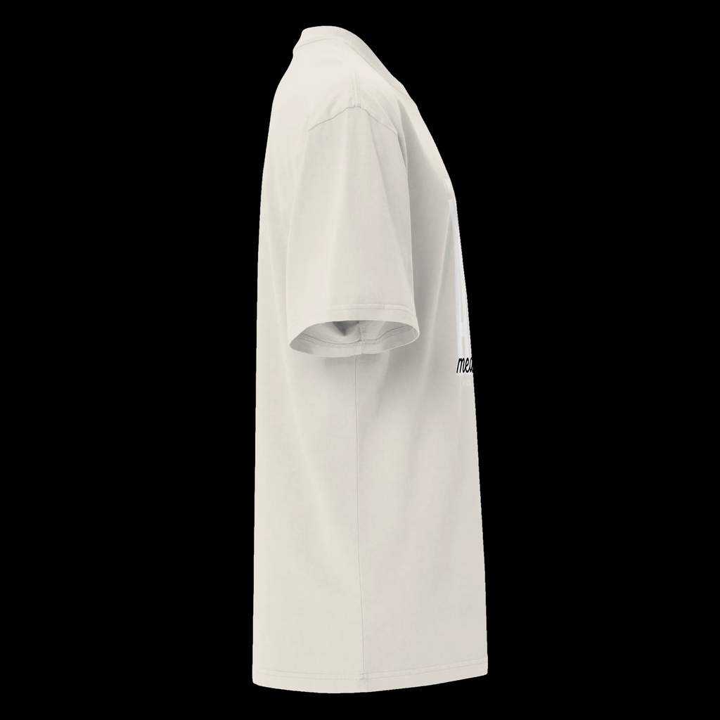 Right-side view of the faded bone oversized tee showing its relaxed silhouette and partial statement design.