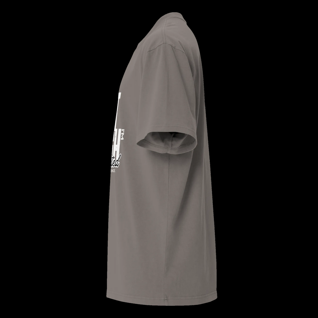 Left-side view of the faded grey oversized tee showing the roomy sleeve, drop shoulder and partial front design.
