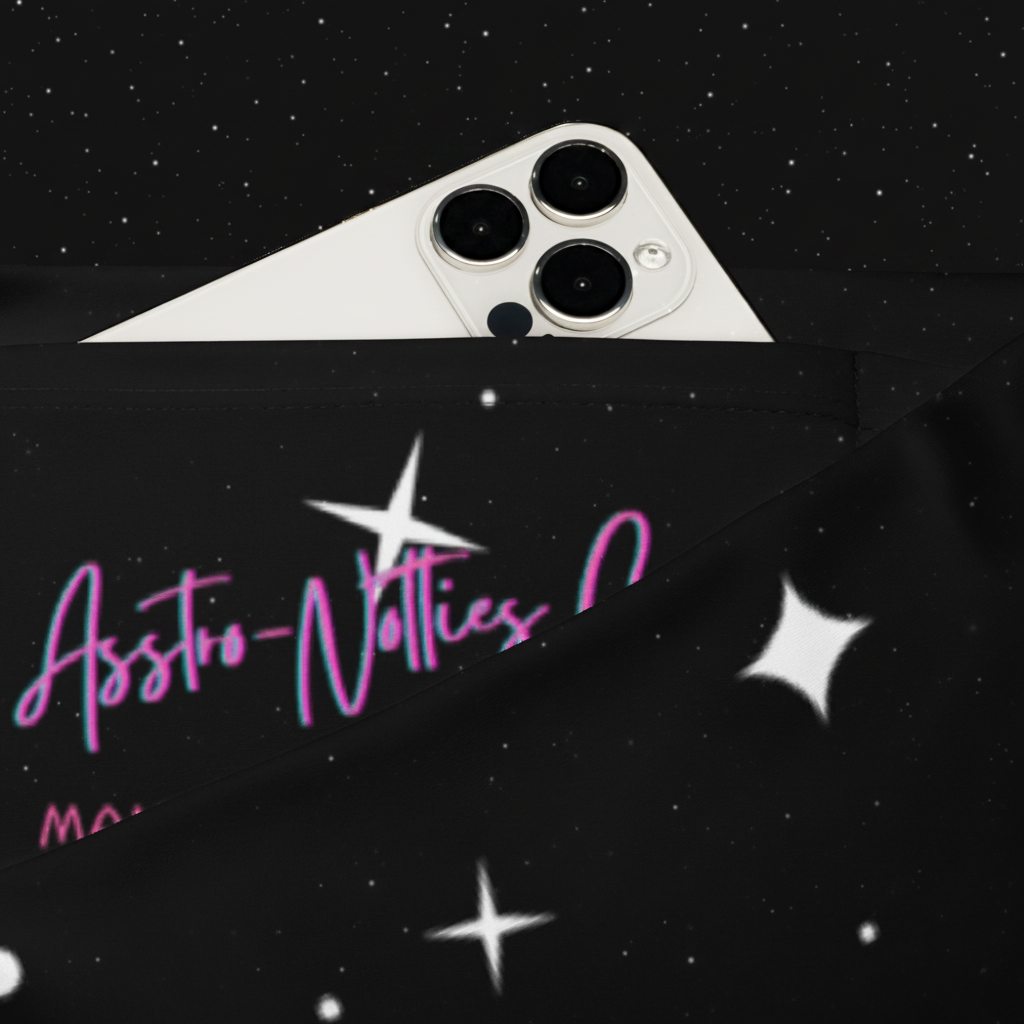 White smartphone secured in the interior waistband pocket of the black celestial flare leggings.