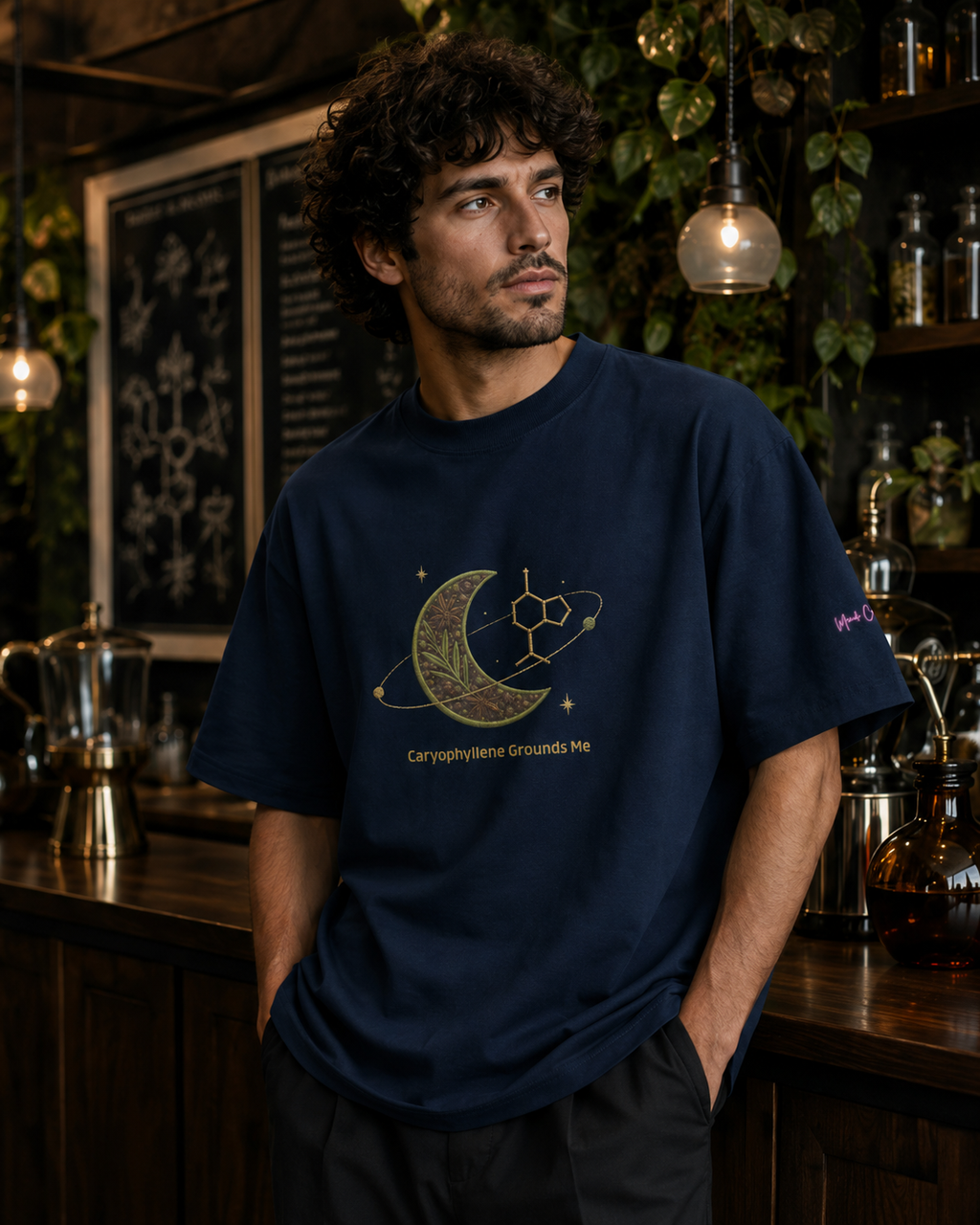 Man wearing the French-navy Caryophyllene Grounds Me oversized tee in a botanical science