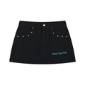 Front product view of the Electric Stardust black denim mini skirt featuring gold-tone studs, front pockets, and electric-blue Mandi Cruz Media script.