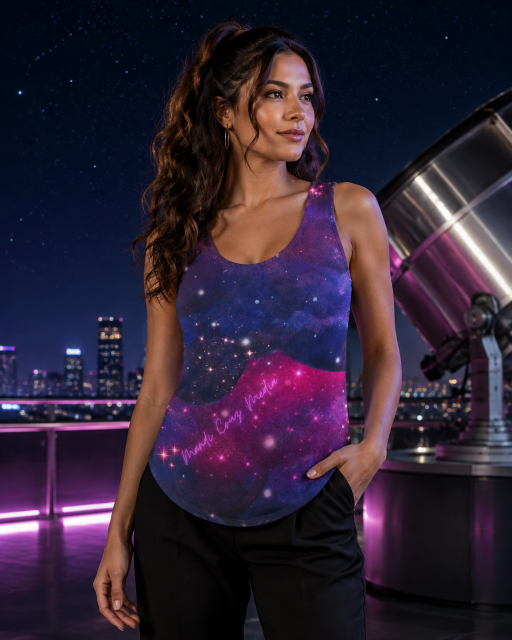 Woman wearing the Mandi Cruz Media galaxy cut-and-sew tank top at a rooftop observatory beneath a star-filled night sky.
