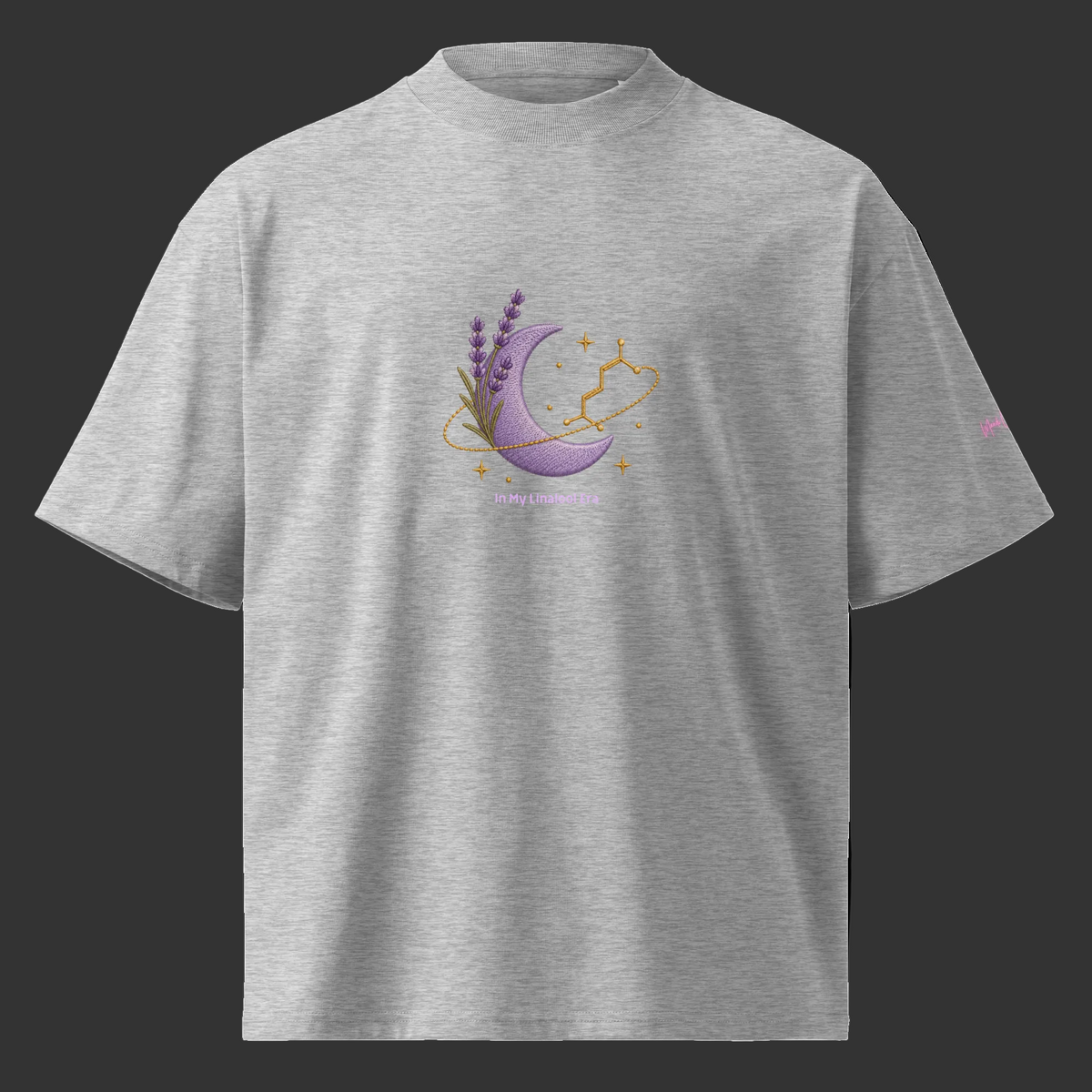 Front view of the heather-grey oversized tee with lavender, a purple crescent moon, linalool molecule and celestial artwork.