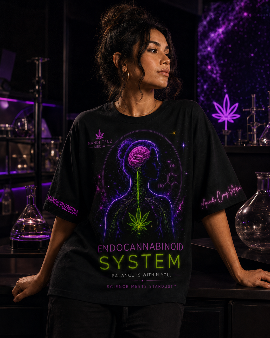 Woman wearing the black neon Endocannabinoid System oversized tee in a purple-lit science studio.