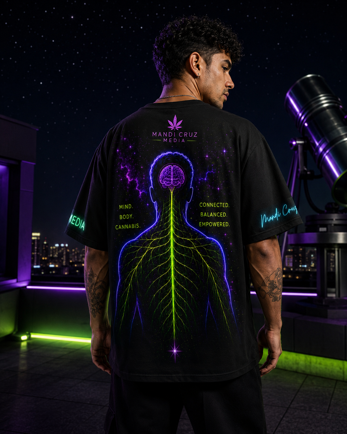 Back lifestyle view of a man wearing the Endocannabinoid System oversized tee at a rooftop observatory beneath a star-filled sky.