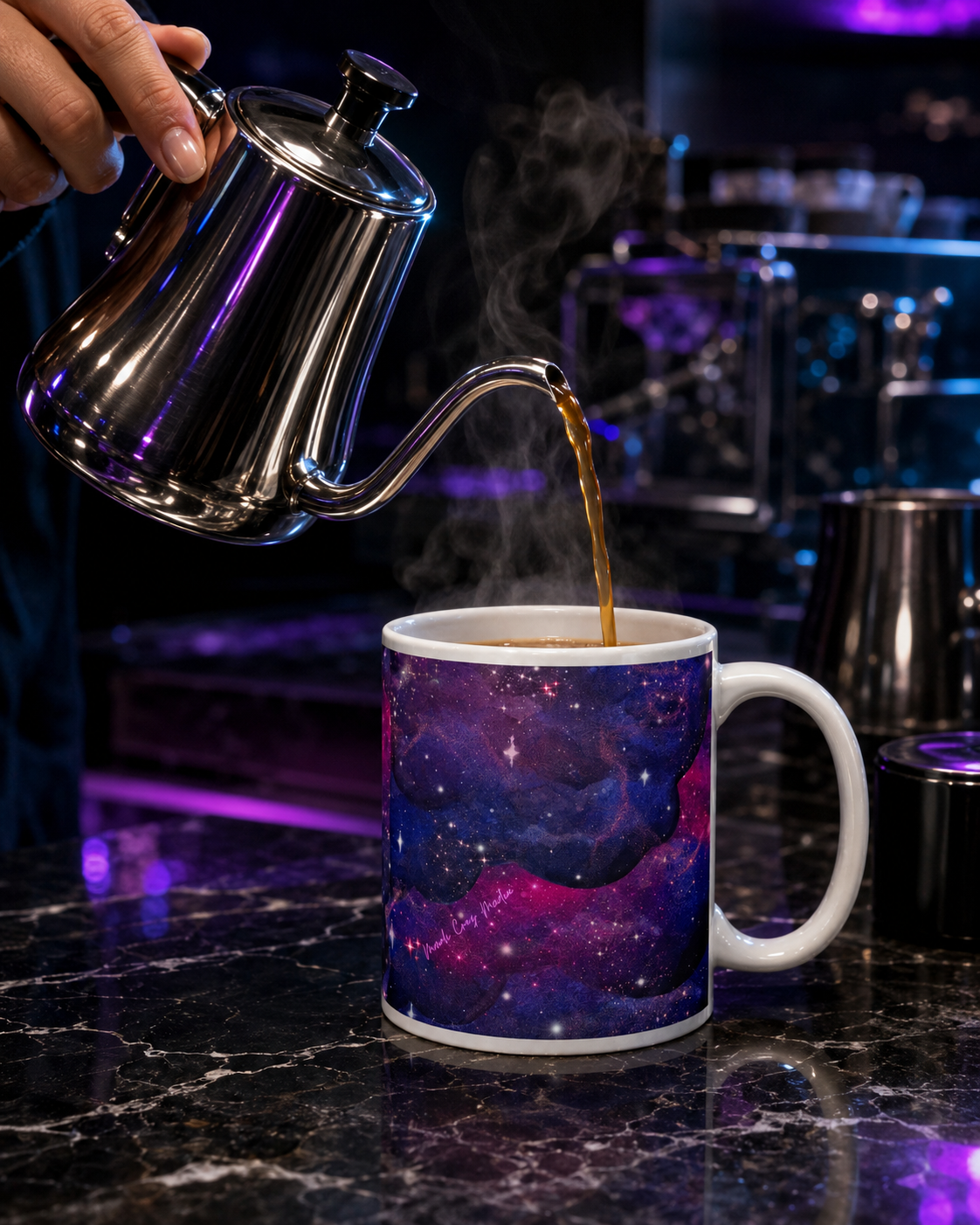 Hot coffee being poured from a silver gooseneck kettle into the Large Nebula Mug on a black marble cosmic café counter.