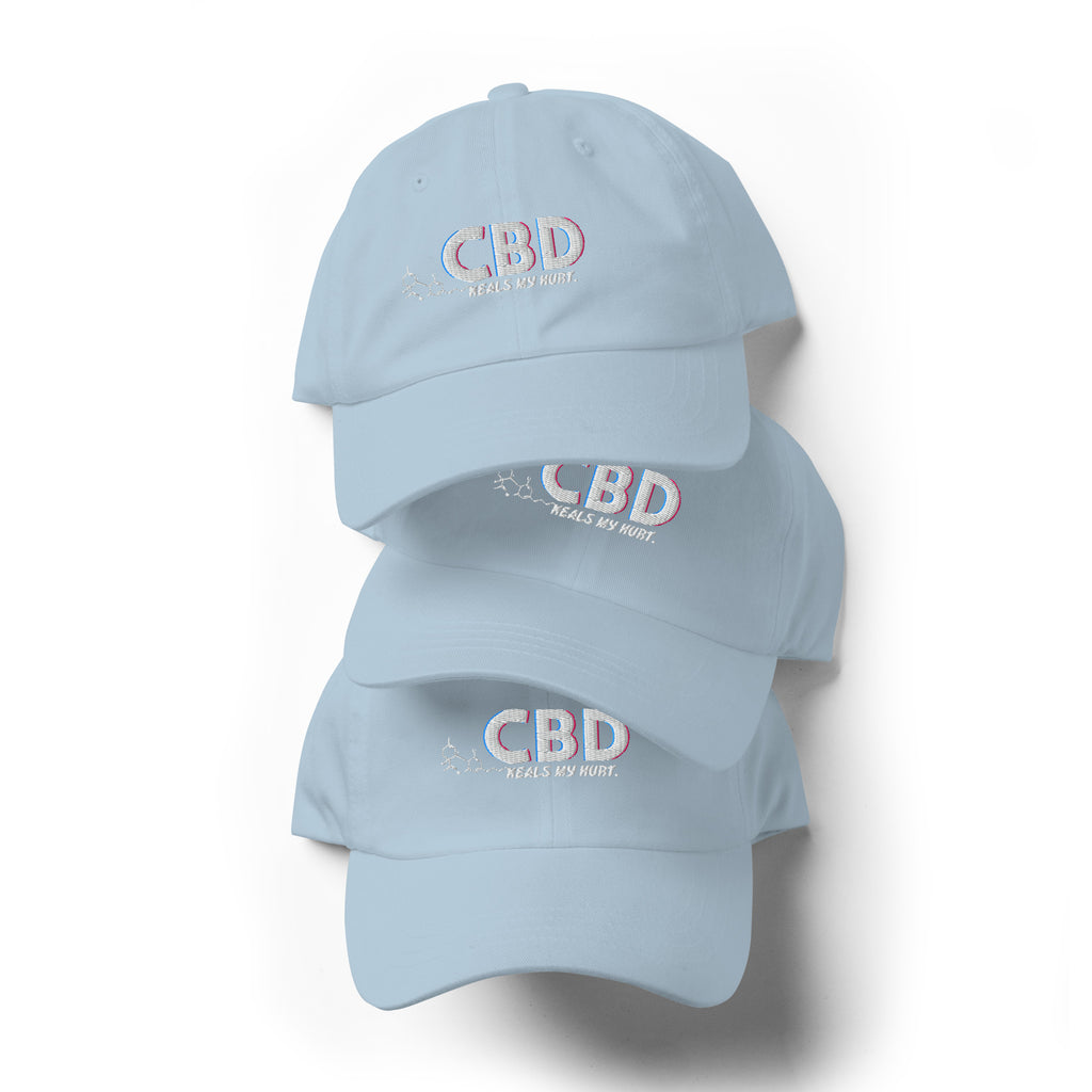 Three light blue CBD Heals My Hurt dad hats arranged vertically with pastel embroidery visible.