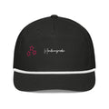 Front product view of the black golf rope cap with white rope trim, pink embroidered stars and white Mandi Cruz Media script.