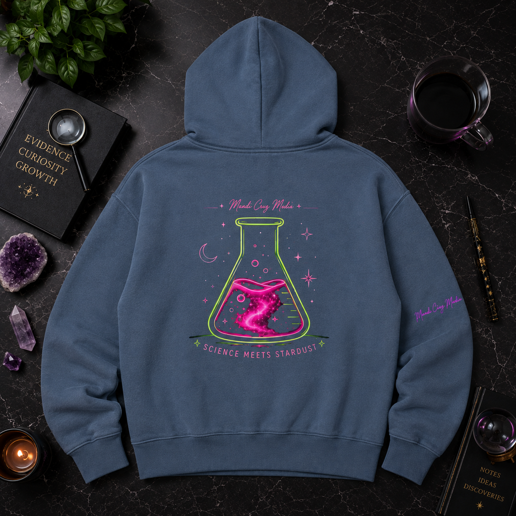 Back flat lay of the blue Mandi Cruz Media hoodie featuring a large pink and green cosmic laboratory flask graphic with Science Meets Stardust lettering.