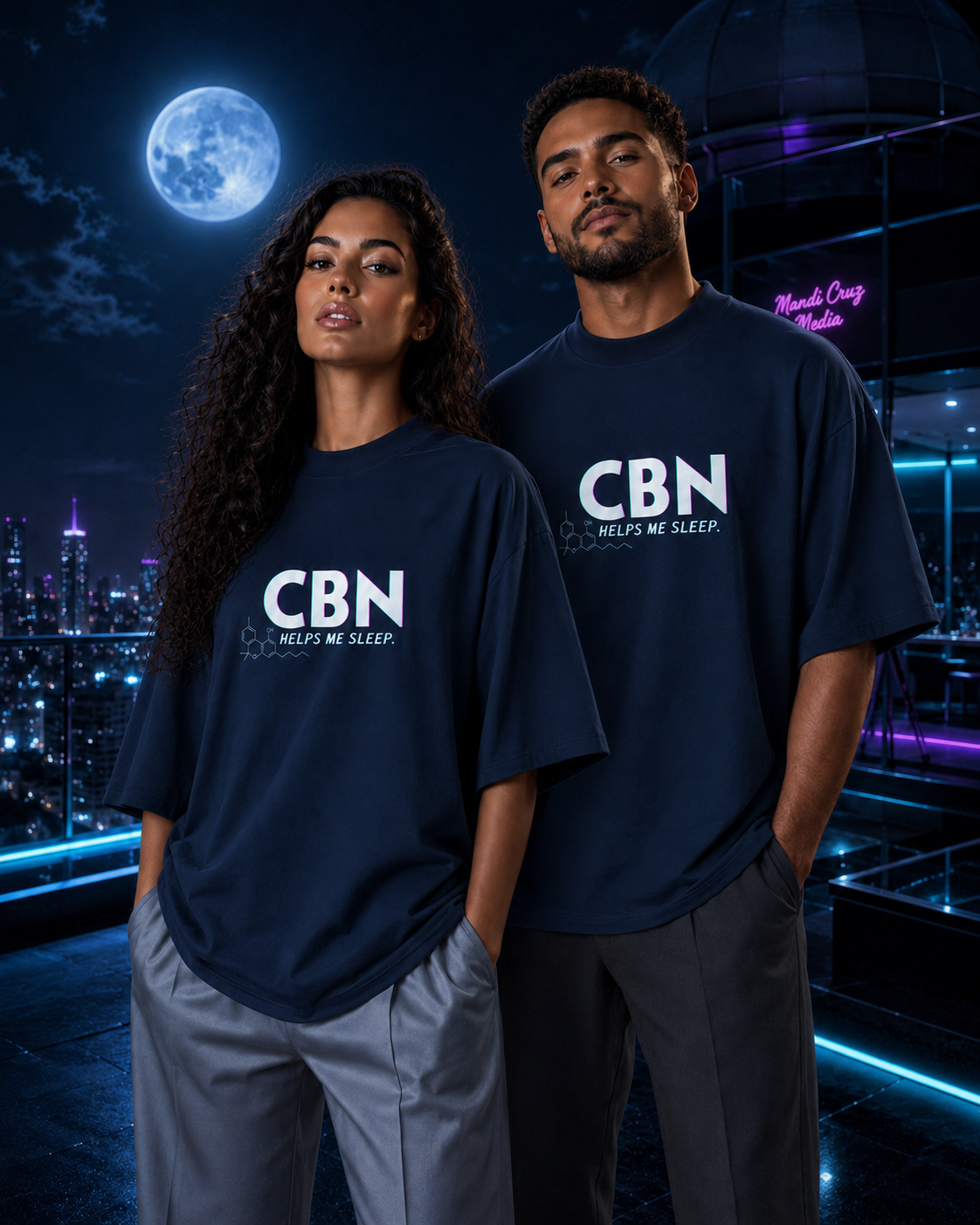 Woman and man modeling matching French Navy CBN Helps Me Sleep tees in a moonlit rooftop observatory.