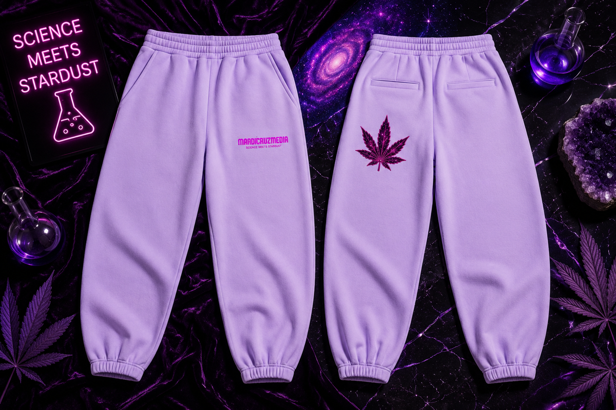 Premium flat lay of lavender Mandi Cruz Media sweatpants showing the front and back, featuring a hot pink Mandi Cruz Media Science Meets Stardust logo on the front and a pink galactic leaf graphic on the back, styled against a black and purple cosmic background.