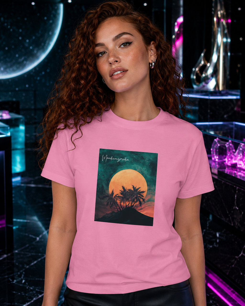 Red-haired woman wearing a pink moon-and-palm graphic T-shirt in a cyan and fuchsia cosmic boutique.