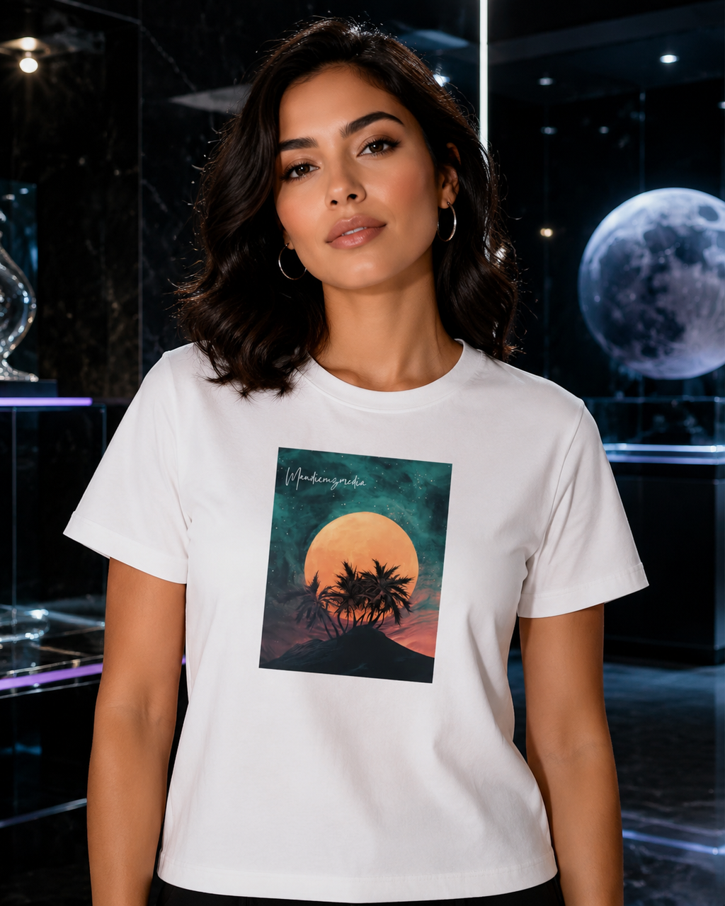 Woman modeling a white moon-and-palm graphic T-shirt in a polished black marble gallery.