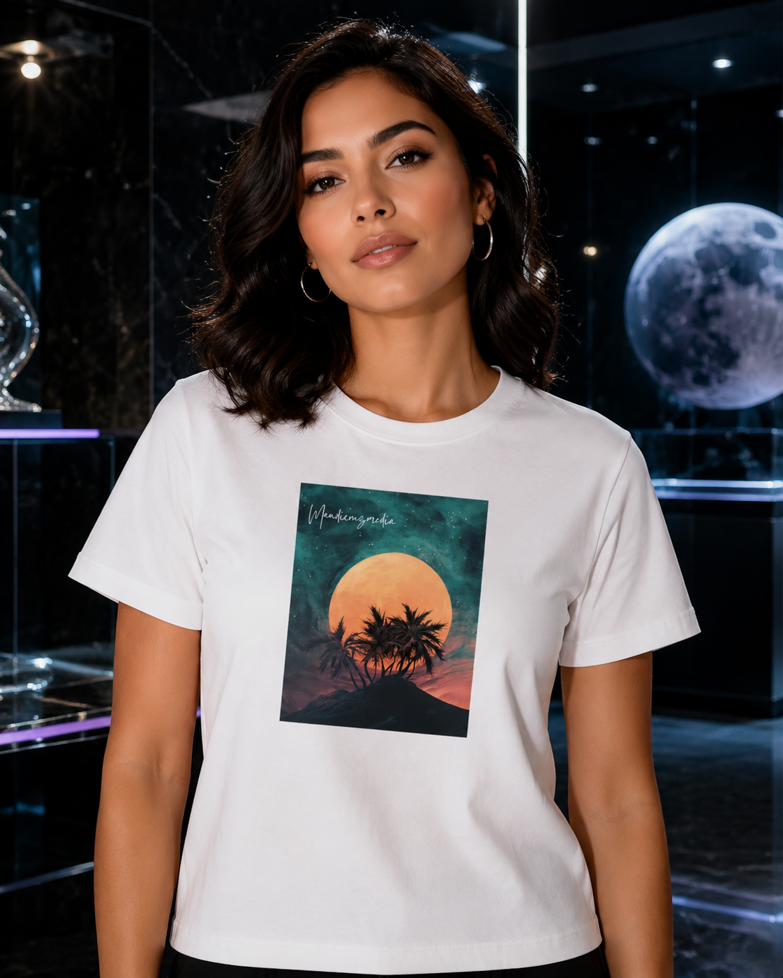 Woman modeling a white moon-and-palm graphic T-shirt in a polished black marble gallery.