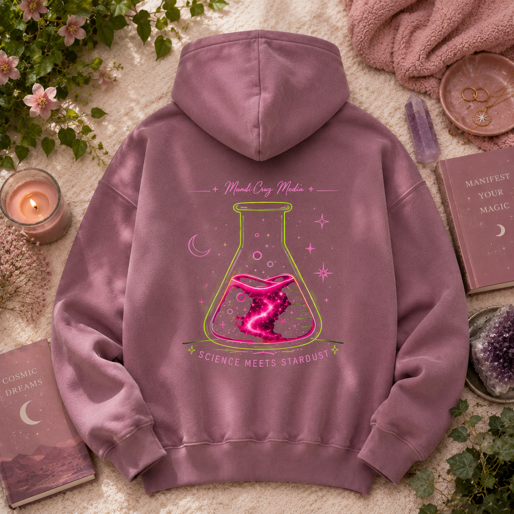 Back of dusty mauve Mandi Cruz Media hoodie featuring the large neon Science Meets Stardust flask graphic in a cozy botanical flat lay with crystals, greenery, and celestial accents.