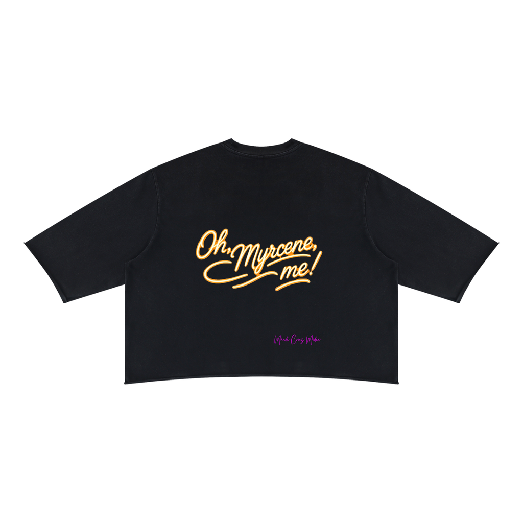 Front product view of the black mineral-wash boxy tee featuring a gold celestial mango, botanical sprigs and myrcene molecule.