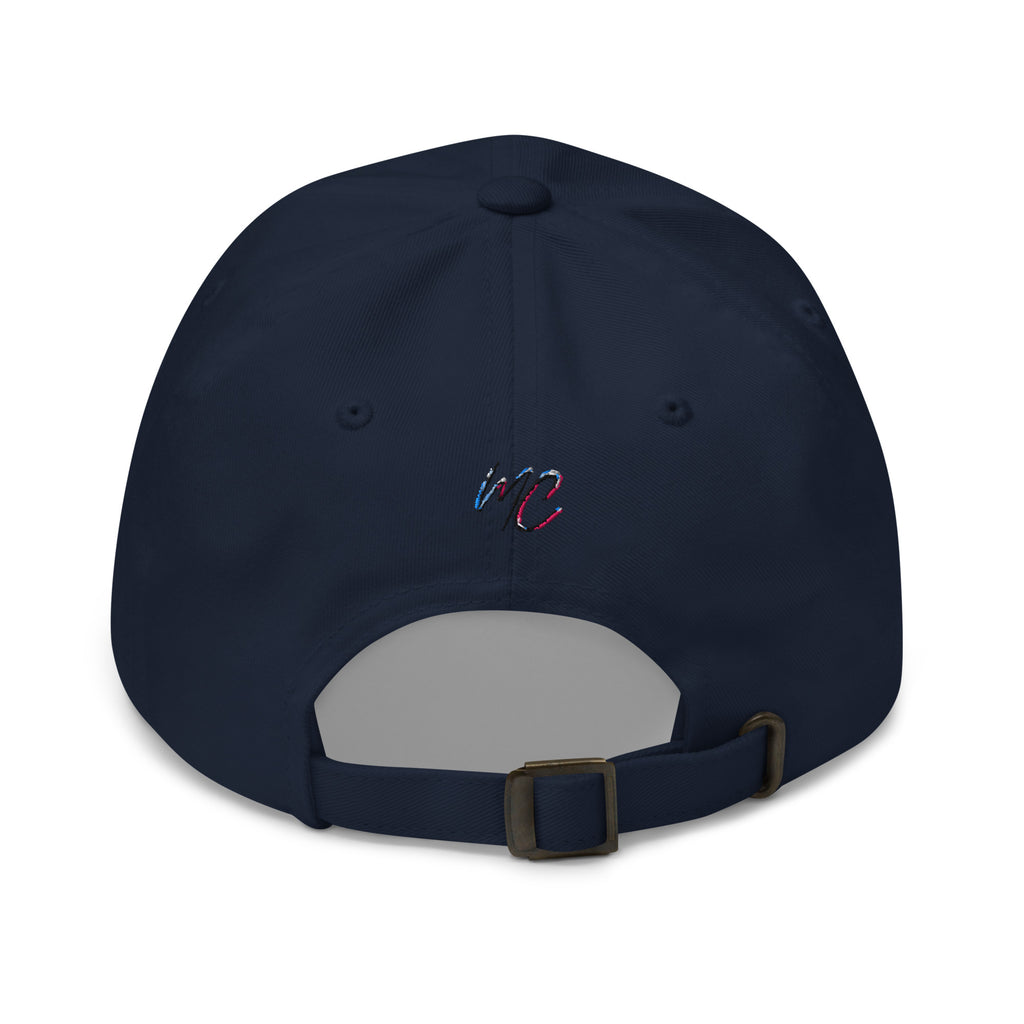 Back view of the navy dad hat showing the small MCM embroidery, adjustable strap and antique buckle.