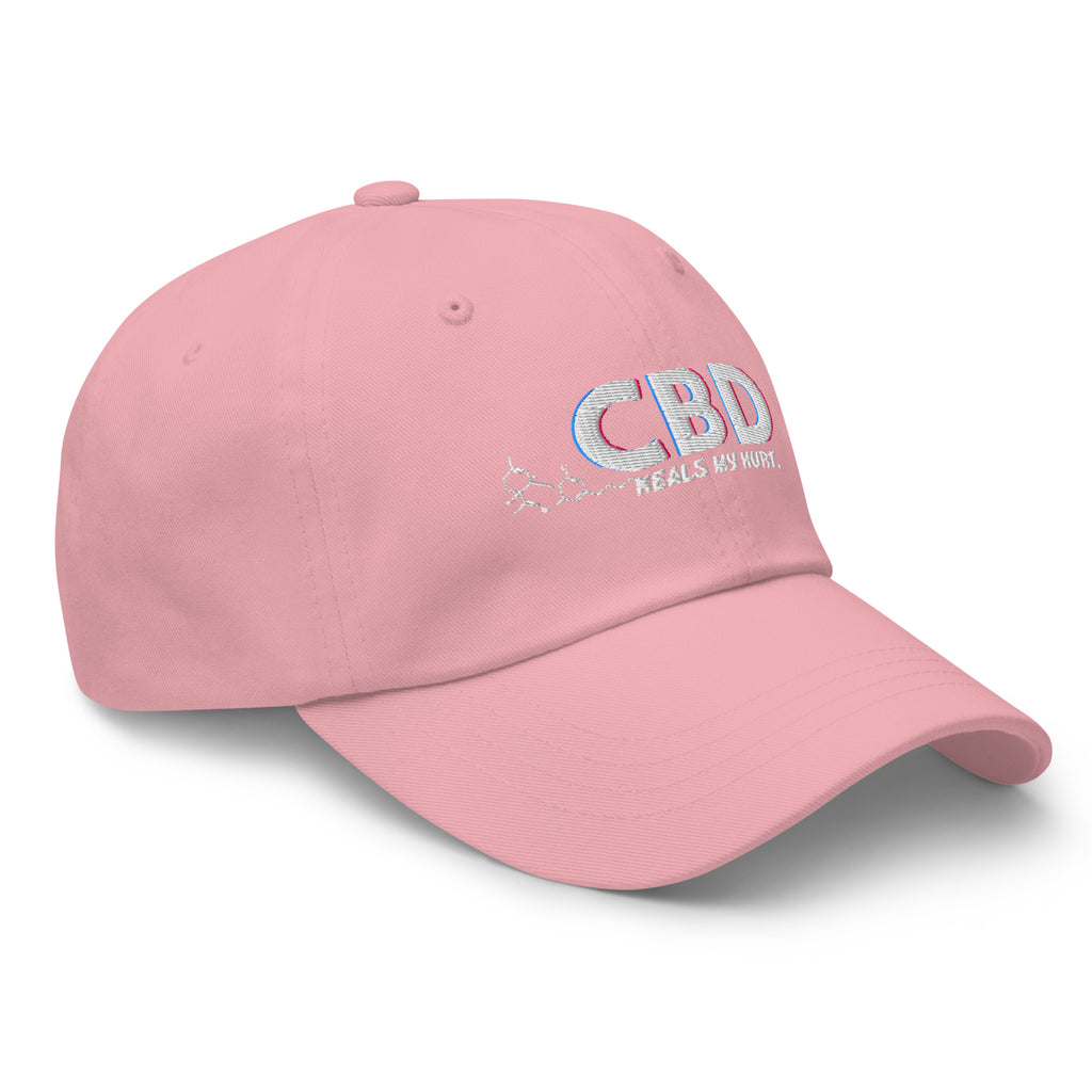 Three-quarter front view of the pink CBD Heals My Hurt dad hat with pastel embroidered lettering.