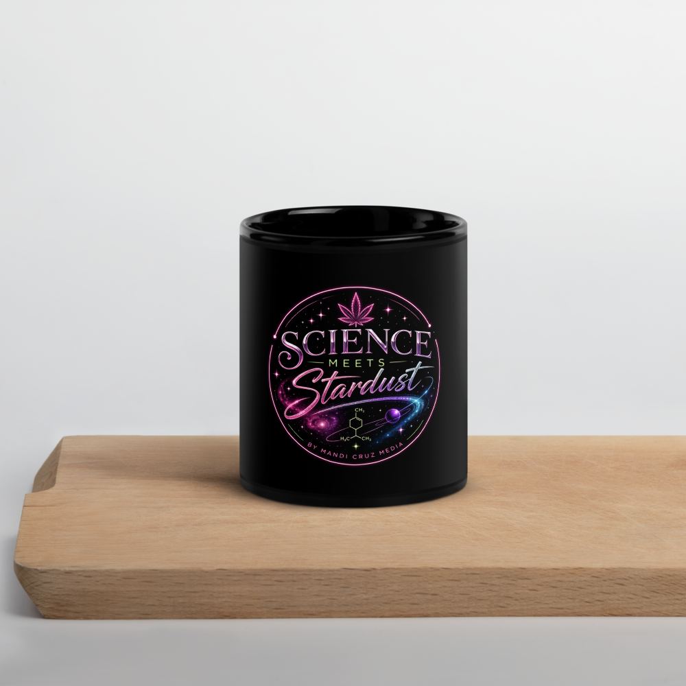 Black Science Meets Stardust coffee mug featuring pink cosmic cannabis and molecular artwork displayed on a natural wood shelf.