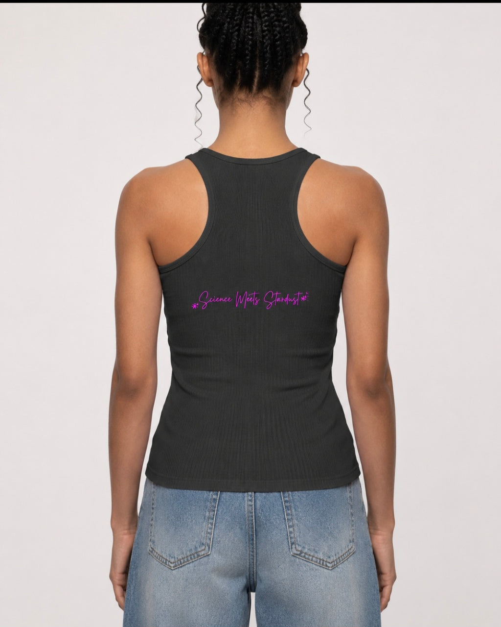 Back view of woman wearing charcoal ribbed racerback tank top featuring pink Science Meets Stardust script by Mandi Cruz Media.