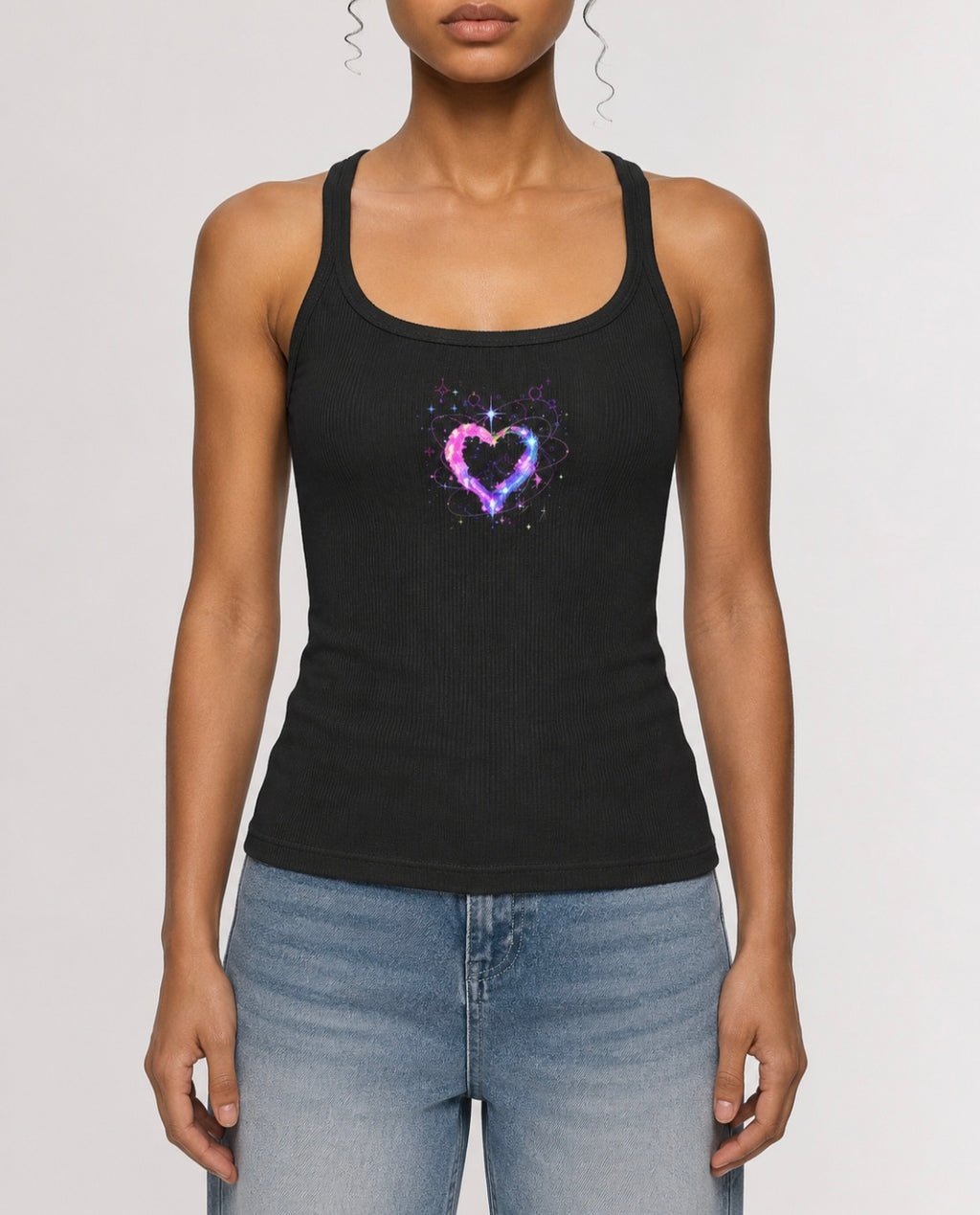 Front view of woman wearing charcoal ribbed racerback tank featuring a pink, purple and blue cosmic heart graphic by Mandi Cruz Media.