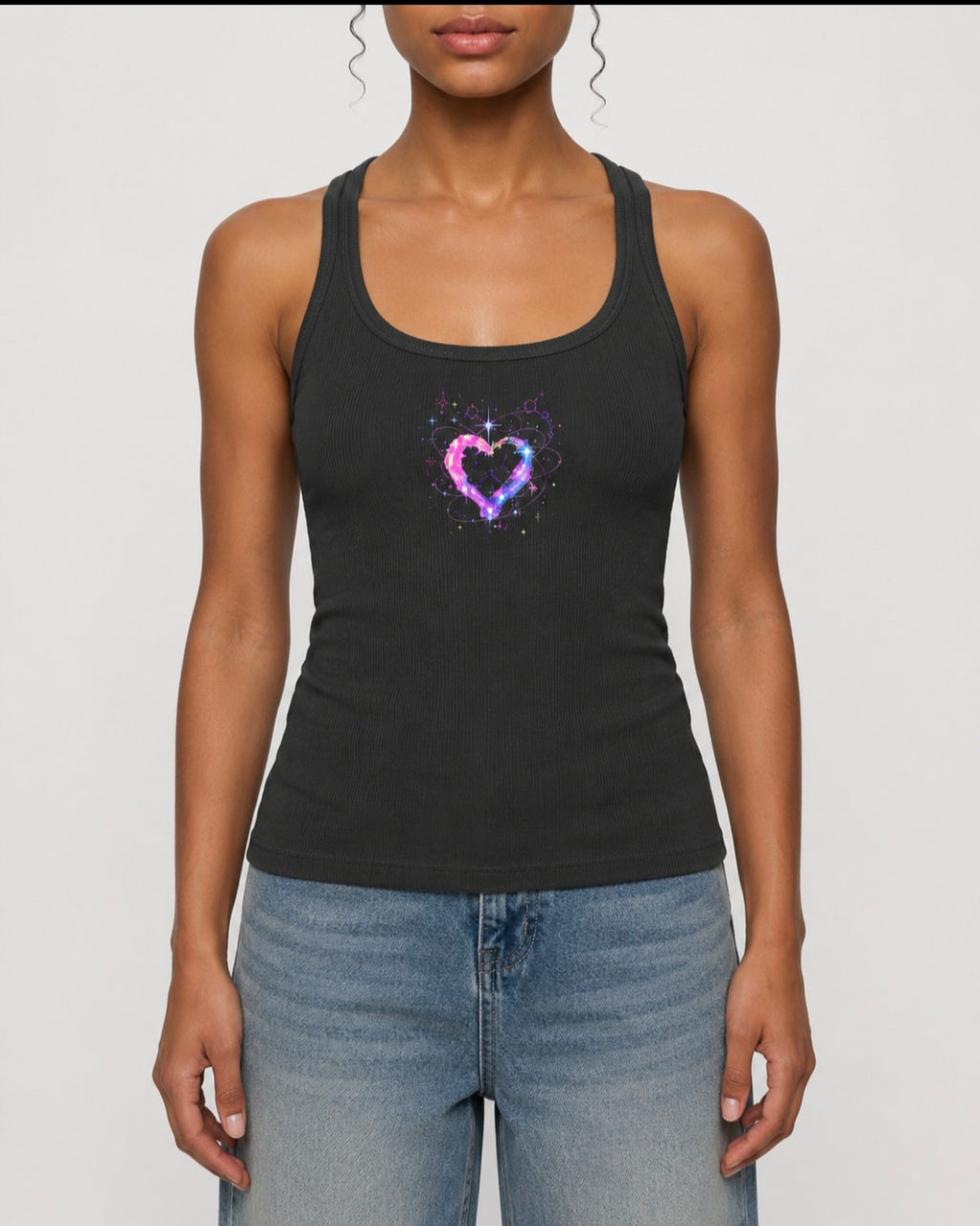 Front view of woman wearing charcoal ribbed racerback tank top featuring a colorful cosmic heart graphic by Mandi Cruz Media.