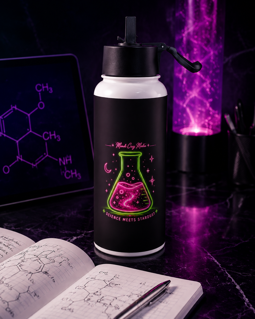 Science Meets Stardust water bottle displayed on a cosmic science desk beside a notebook with chemistry sketches.