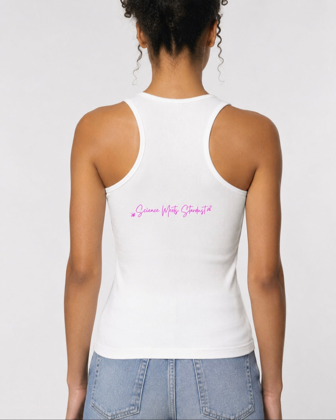 Back view of woman wearing white racerback tank with pink Science Meets Stardust script