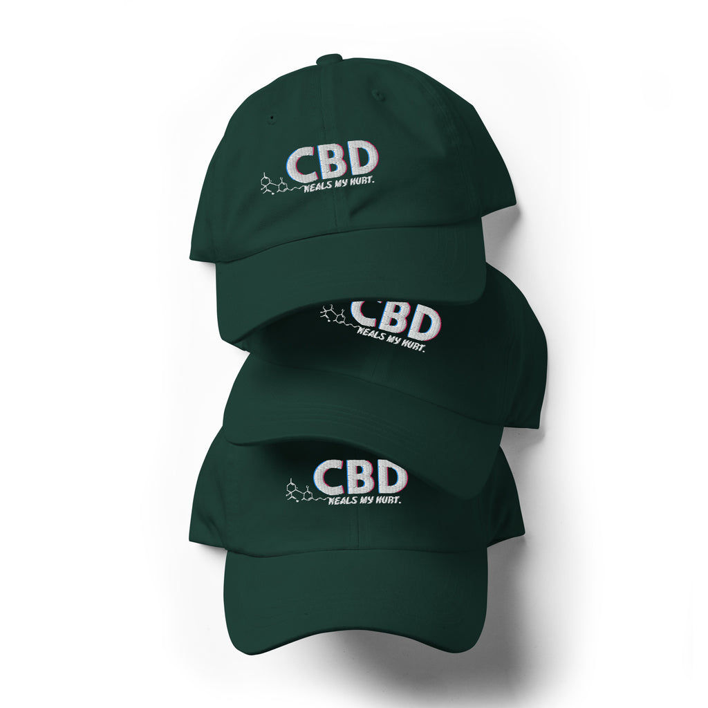 Three spruce green CBD Heals My Hurt dad hats arranged vertically with the embroidered fronts visible.