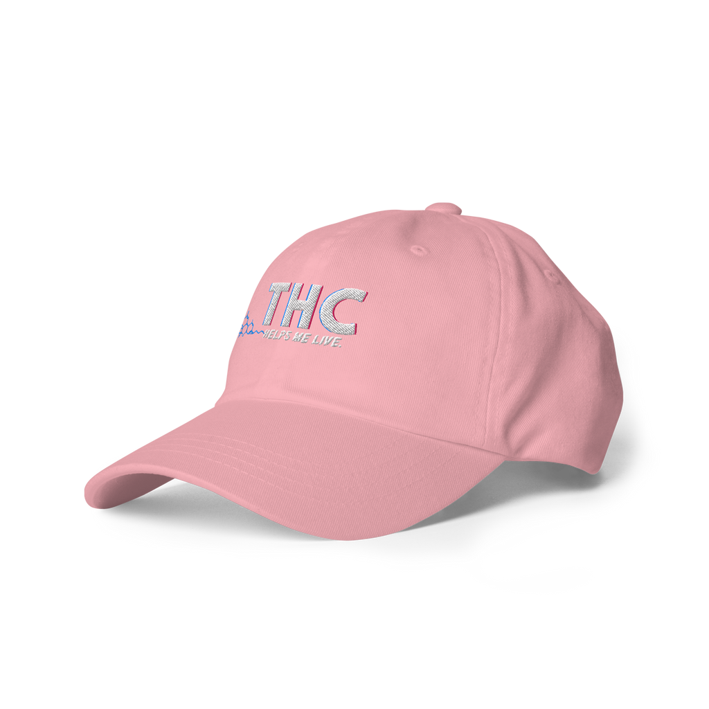 Left-front product view of the soft pink dad hat featuring embroidered THC Helps Me Live artwork.