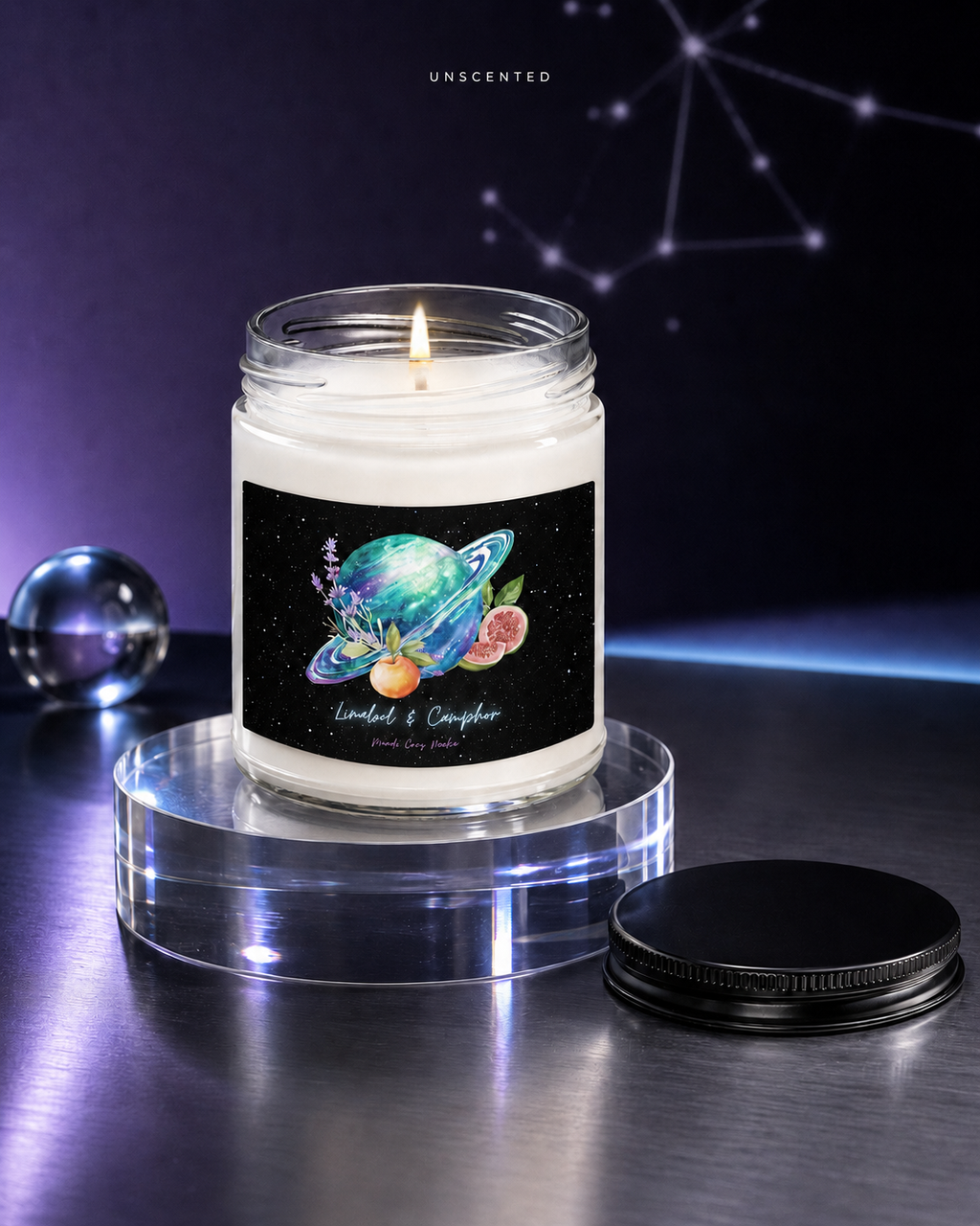 Unscented Mandi Cruz Media soy candle displayed on clear acrylic in a minimalist violet and silver studio.