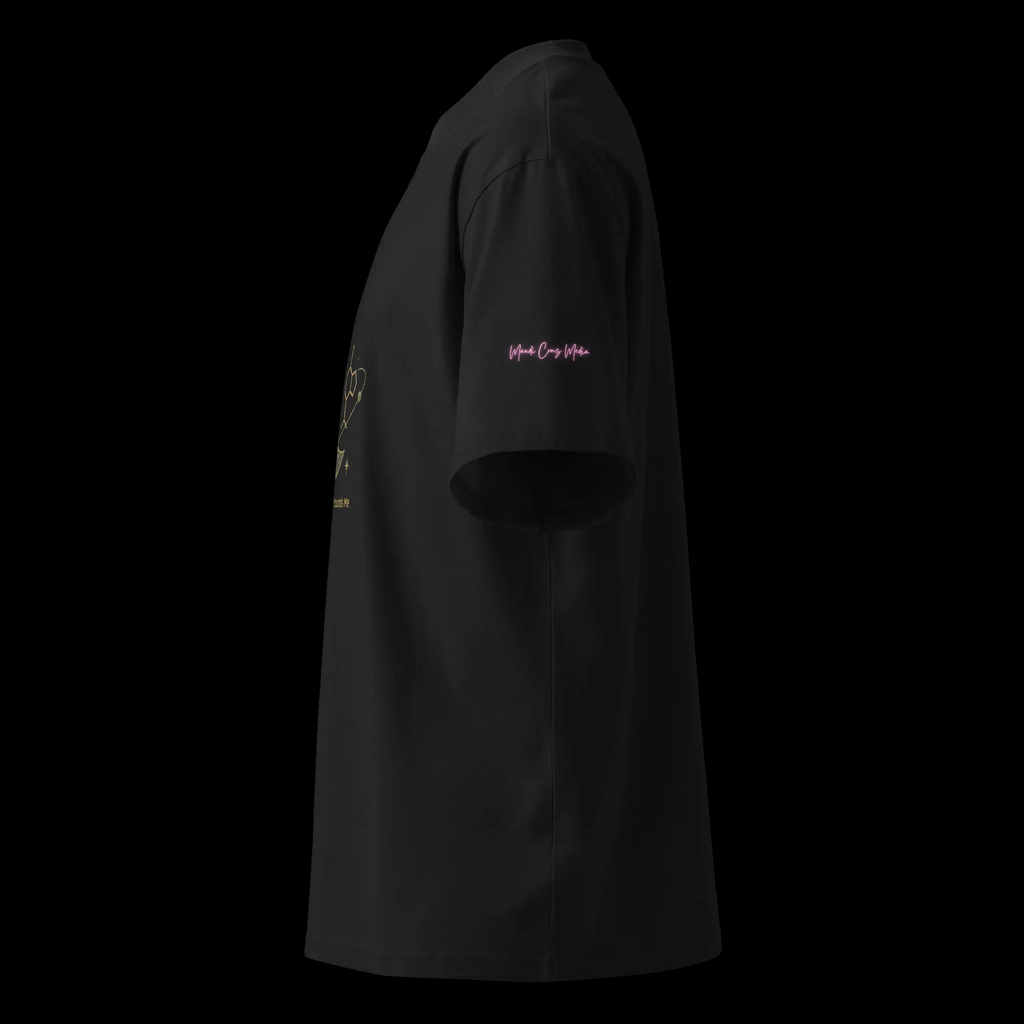 Left-side view of the white oversized tee showing its relaxed silhouette and pink Mandi Cruz Media sleeve signature.