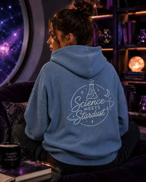 Lifestyle back view of the Beaker™ Vintage Wash Waffle Boxy Hoodie by Mandi Cruz Media showing the oversized fit and signature graphic artwork.