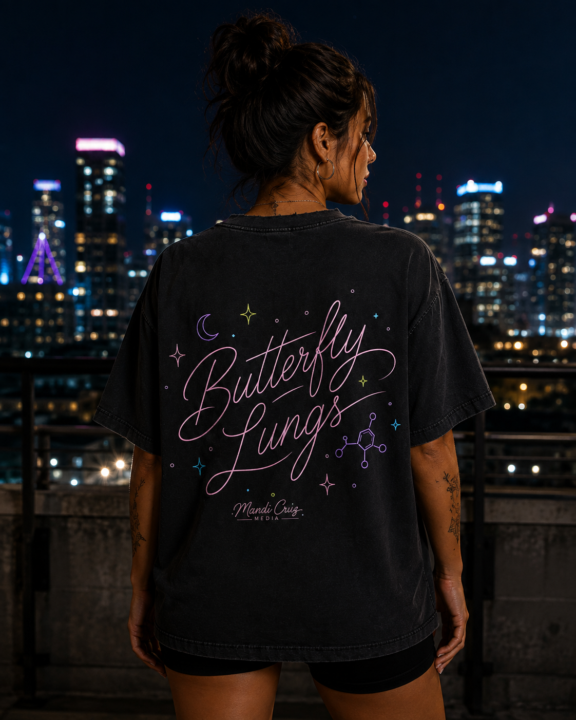 Lifestyle back view of a model wearing the Mandi Cruz Media Butterfly Lungs™ vintage washed T-shirt highlighting the signature graphic artwork.
