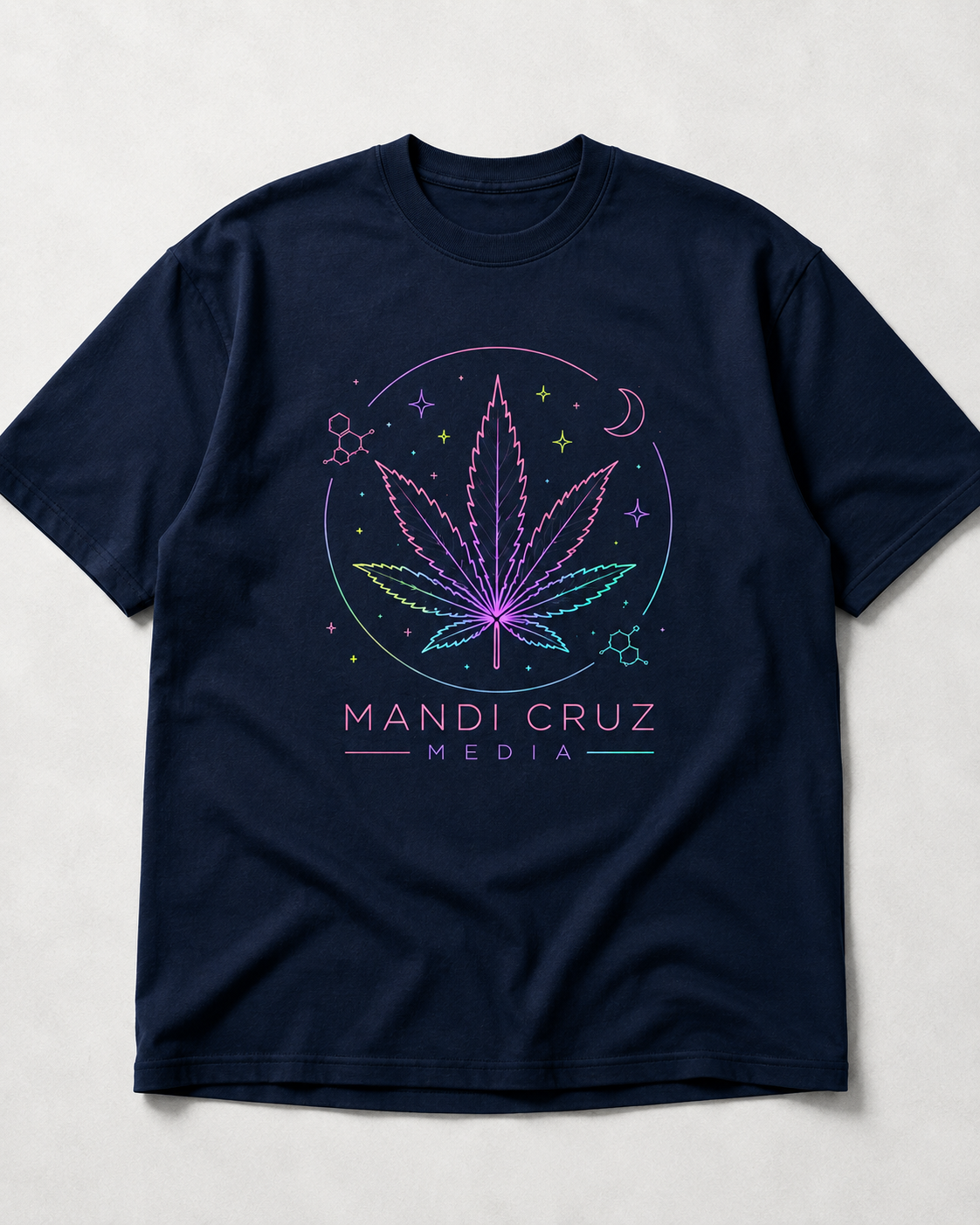 Front view of navy blue Mandi Cruz Media drop shoulder T-shirt featuring a colorful celestial cannabis leaf graphic.