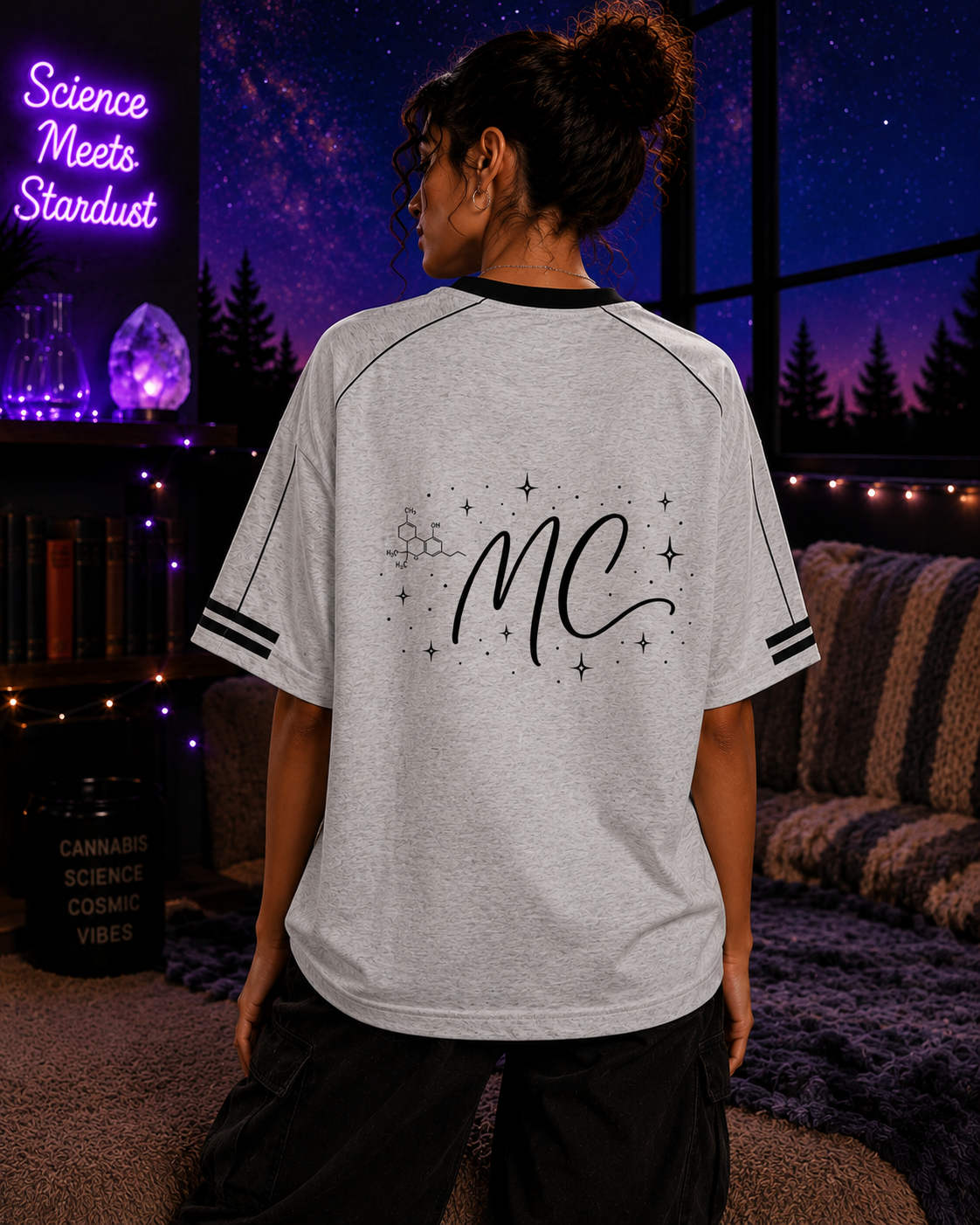 Back lifestyle view of a woman wearing the Flower Gray Mandi Cruz Media Signature™ Raglan Tee featuring the MC celestial graphic.