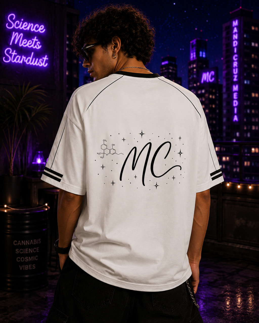 Back lifestyle view of a man wearing the white Mandi Cruz Media Signature™ Raglan Tee featuring the MC monogram, molecule, and celestial artwork.