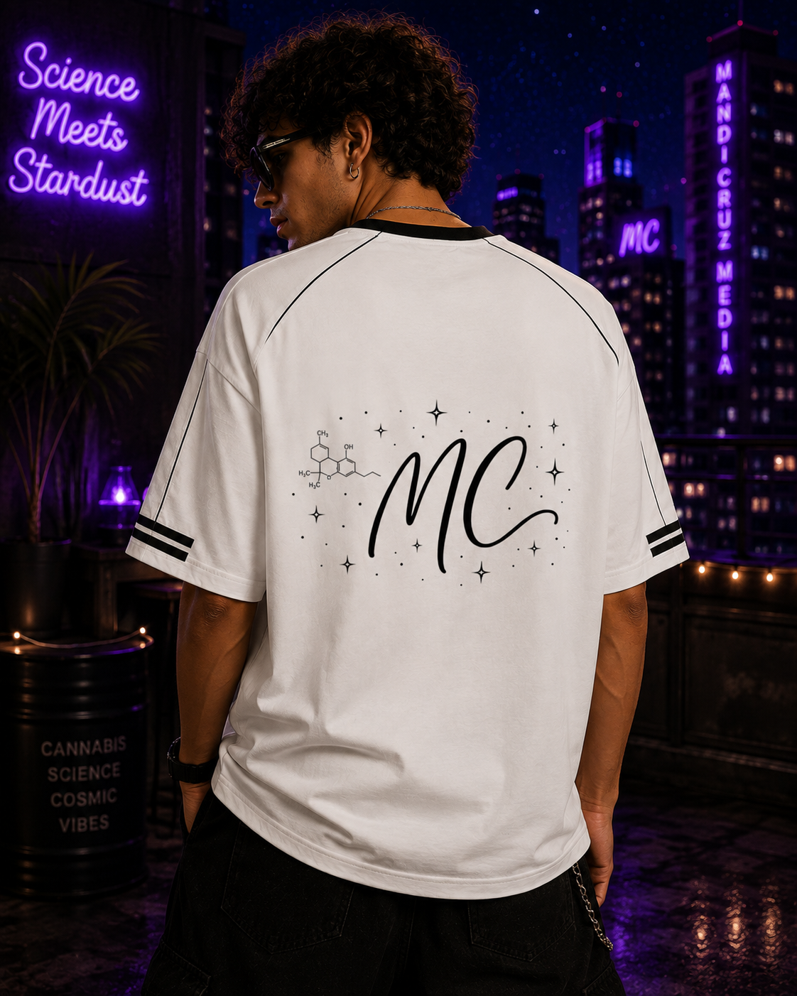 Back lifestyle view of a man wearing the white Mandi Cruz Media Signature™ Raglan Tee featuring the MC monogram, molecule, and celestial artwork.